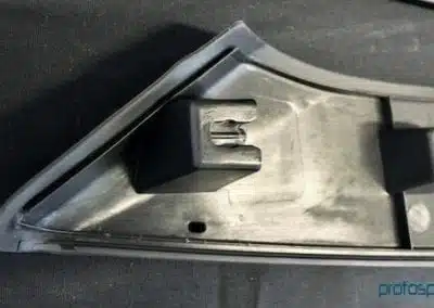 a black plastic object with a black plastic object on a black surface