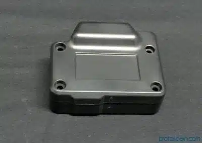 a black plastic box with screws