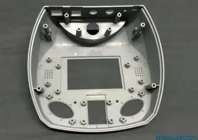 a grey plastic object with holes