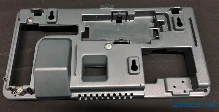 molde-prototipado-ingenieria-pc+abs-placa-soporte-1 a grey plastic object with holes