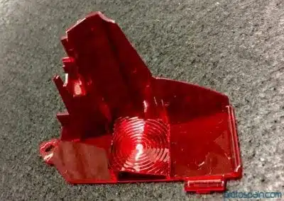 a red object on a black surface