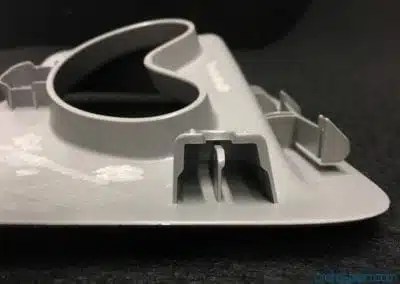 a grey plastic object with a hole