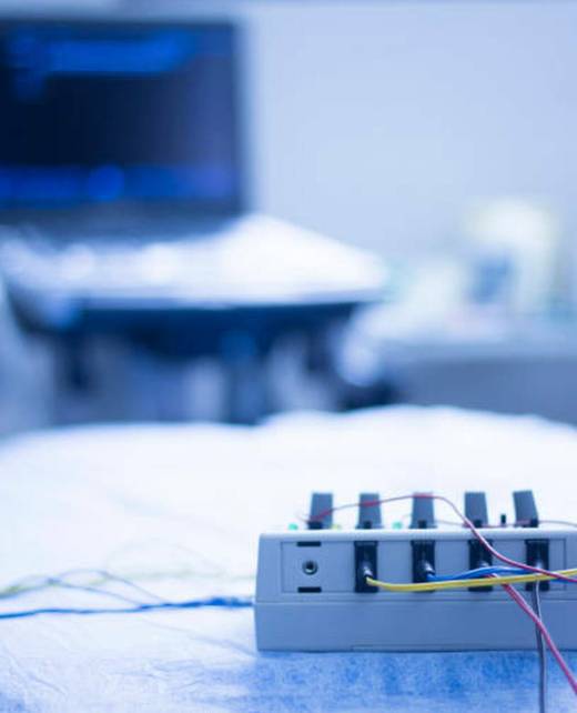 Dry needling electroacupunture machine connected to needles used by acupunturist on patient in pain and injury acupunture with electrical pulse treatment.  No model releases or property releases required as no recognisable people and generic objects and place.